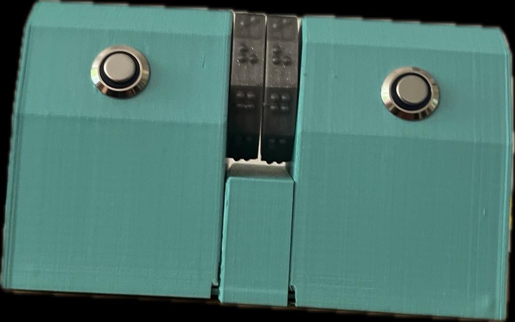 Foto des Thermometers: Ein 3D-gedrucktes Gehäuse mit zwei silbernen Drucktastern links und rechts sowie zwei beweglichen Braille-Walzen in der Mitte